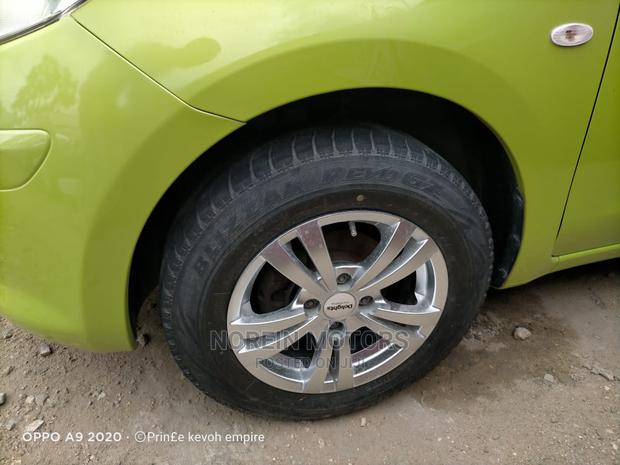 Eco-Friendly 2014 Nissan March Green: Compact Car for Modern Drivers