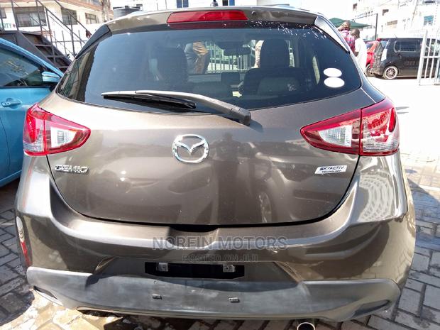 Brown Mazda Demio 2015: Stylish and Efficient Compact Car!