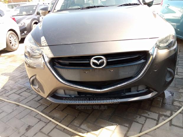 Brown Mazda Demio 2015: Stylish and Efficient Compact Car!