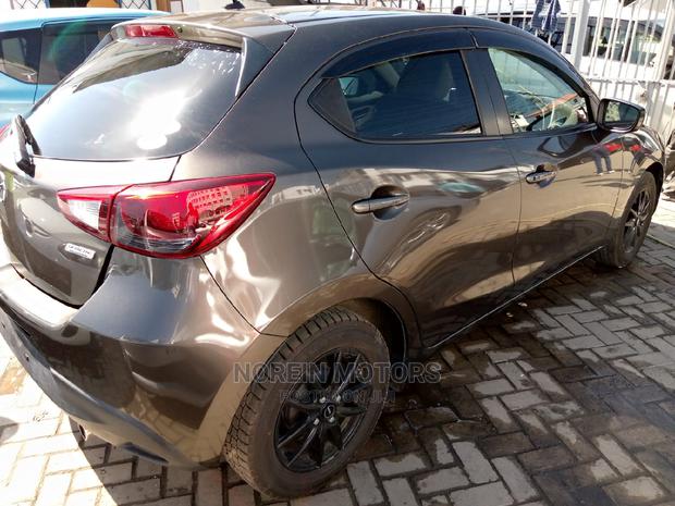 Brown Mazda Demio 2015: Stylish and Efficient Compact Car!