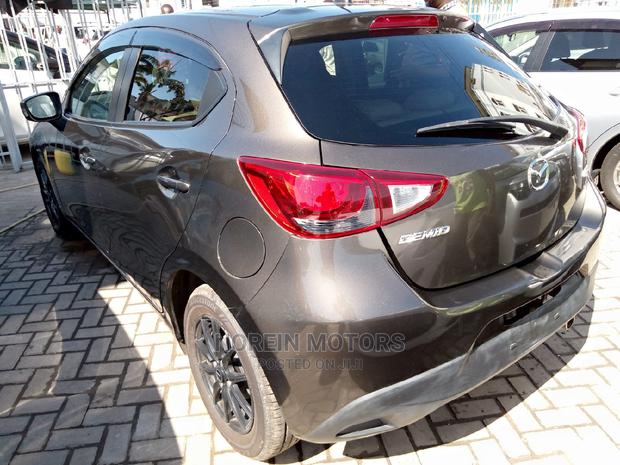 Brown Mazda Demio 2015: Stylish and Efficient Compact Car!