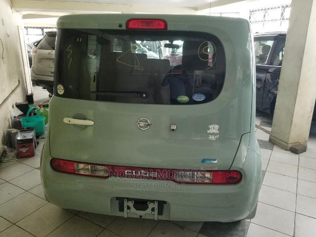 Green 2014 Nissan Cube: Compact Car with Style and Sustainability