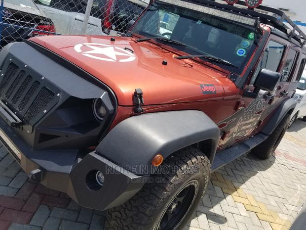 Orange Jeep Wrangler 2014 - Pre-owned SUV for Adventure