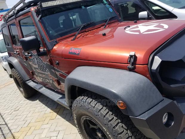 Orange Jeep Wrangler 2014 - Pre-owned SUV for Adventure