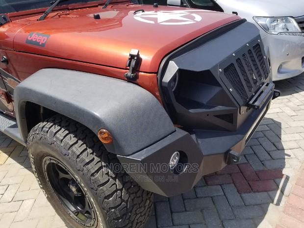 Orange Jeep Wrangler 2014 - Pre-owned SUV for Adventure