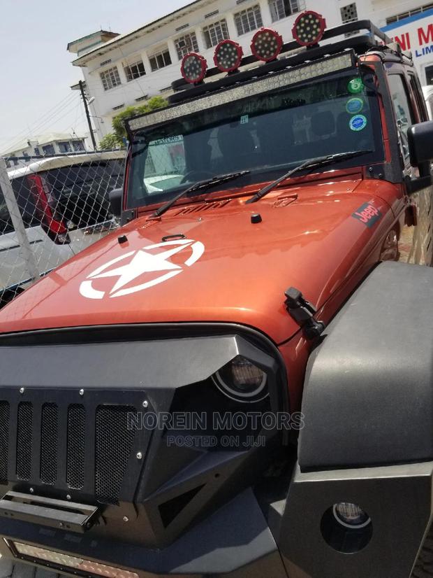 Orange Jeep Wrangler 2014 - Pre-owned SUV for Adventure