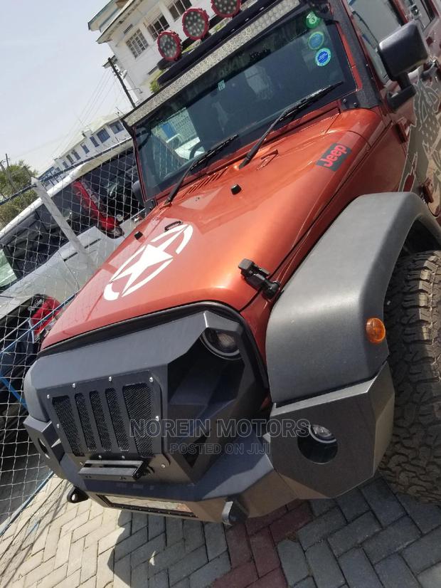 Orange Jeep Wrangler 2014 - Pre-owned SUV for Adventure
