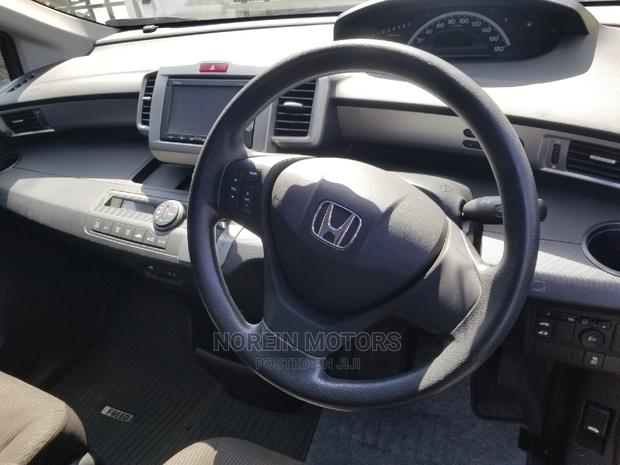 Red Honda Freed 2015: Efficient and Spacious Compact MPV