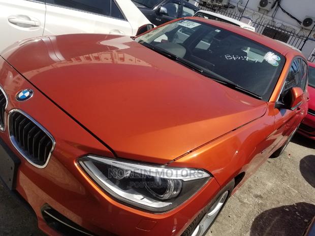 Orange 2015 BMW 116i: Luxury Compact Car with Style