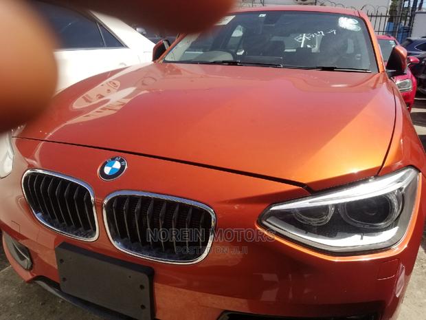 Orange 2015 BMW 116i: Luxury Compact Car with Style