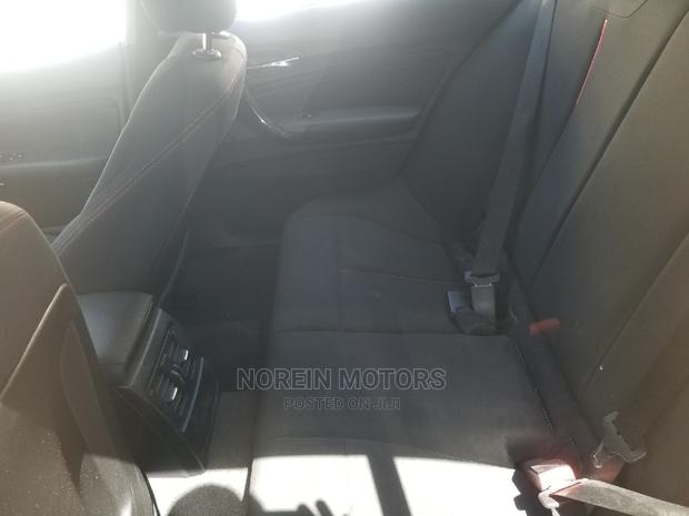 Orange 2015 BMW 116i: Luxury Compact Car with Style