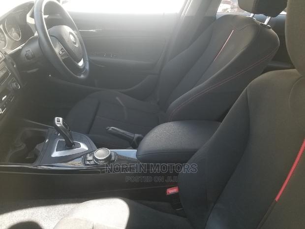 Orange 2015 BMW 116i: Luxury Compact Car with Style