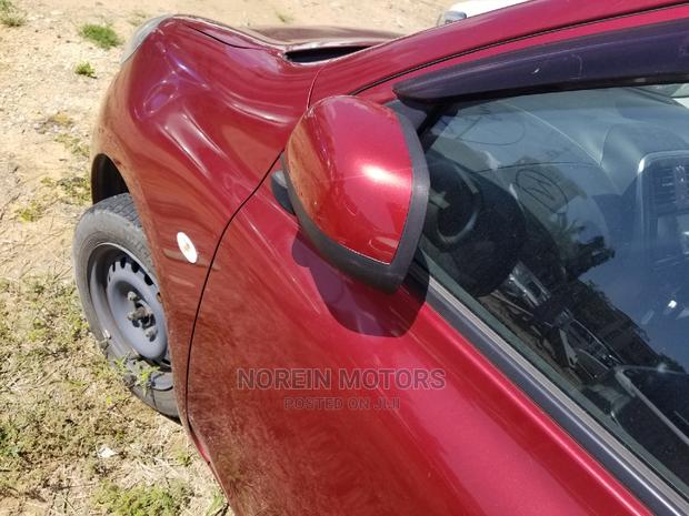 Red 2015 Nissan March: A Compact Car with Charm & Efficiency