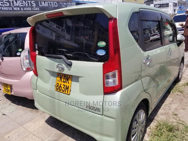 Eco-Conscious: 2015 Daihatsu Move Green - Compact, Efficient, and Stylish!