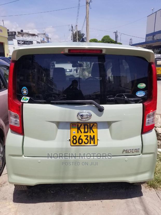 Eco-Conscious: 2015 Daihatsu Move Green - Compact, Efficient, and Stylish!