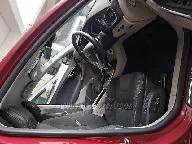 Volvo V40 2015 - Red Sedan: Stylish and sophisticated, this Volvo V40 2015 Red Sedan offers a blend of power and elegance.