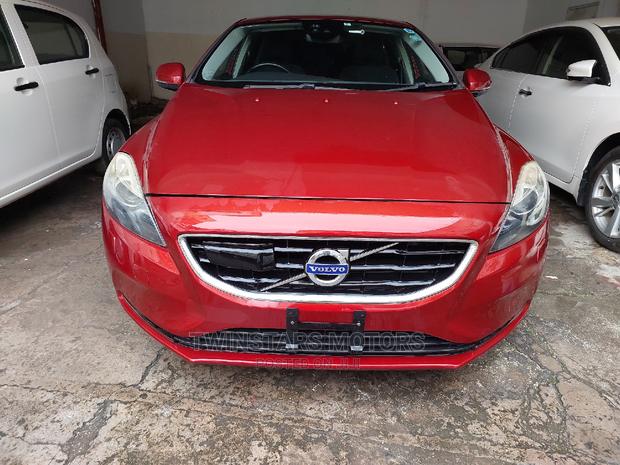 Volvo V40 2015 - Red Sedan: Stylish and sophisticated, this Volvo V40 2015 Red Sedan offers a blend of power and elegance.