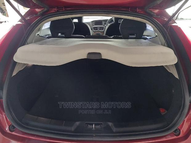 Volvo V40 2015 - Red Sedan: Stylish and sophisticated, this Volvo V40 2015 Red Sedan offers a blend of power and elegance.