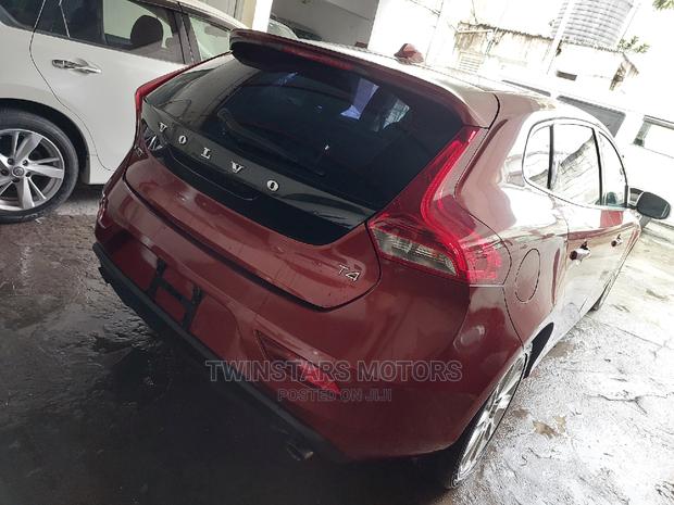 Volvo V40 2015 - Red Sedan: Stylish and sophisticated, this Volvo V40 2015 Red Sedan offers a blend of power and elegance.