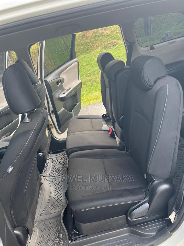 2010 Pearl Toyota Wish - Pre-Owned Sedan with Style and Comfort