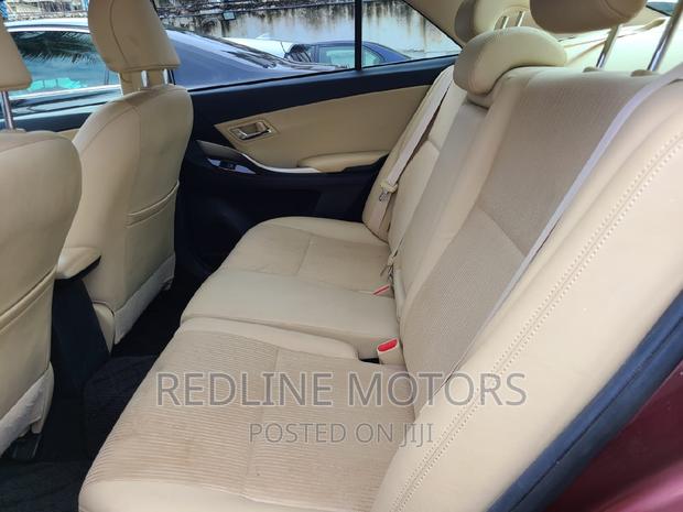 16 Toyota Premio Red Hatchback with 45,000 miles, manual transmission, and sunroof.