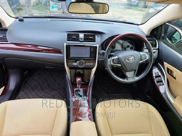 16 Toyota Premio Red Hatchback with 45,000 miles, manual transmission, and sunroof.