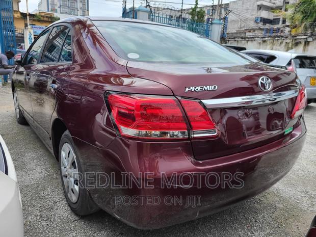 16 Toyota Premio Red Hatchback with 45,000 miles, manual transmission, and sunroof.
