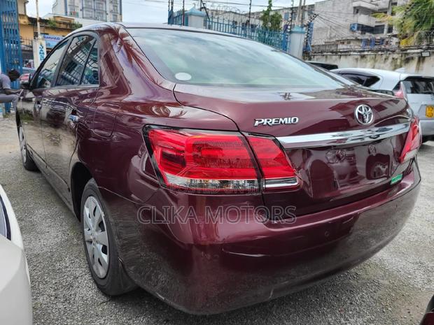 16 Toyota Premio Red Hatchback with 45,000 miles, manual transmission, and sunroof.