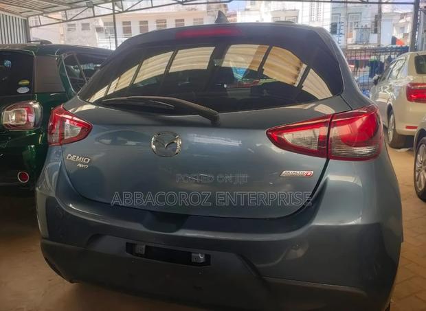 Teal Mazda Demio 2016: Compact Car with Style and Comfort