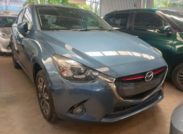 Teal Mazda Demio 2016: Compact Car with Style and Comfort