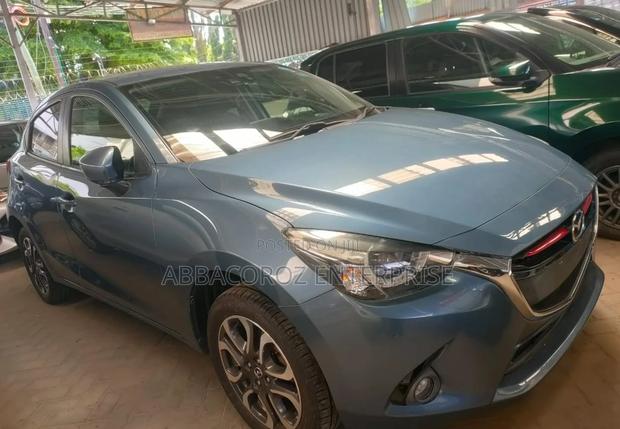Teal Mazda Demio 2016: Compact Car with Style and Comfort